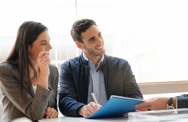 Young couple meeting financial advisor for home investment
